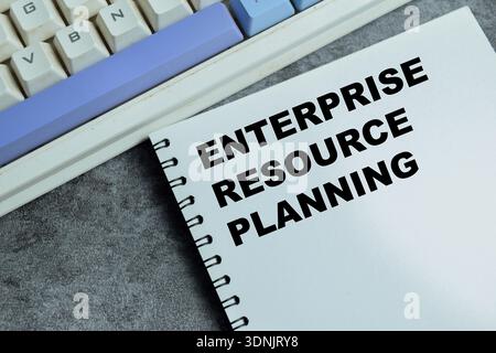 Concept of enterprise resource planning write on book with isolated on Wooden Table. Representing business process management, corporate workflow and Stock Photo