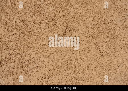 Beige plaster wall texture with rough surface and natural imperfections. Traditional Middle Eastern architectural background  Stock Photo
