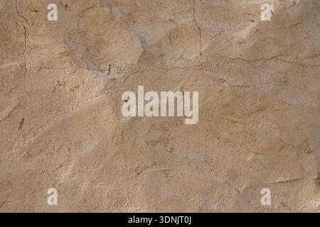 Authentic Middle Eastern wall texture with handcrafted plaster surface and subtle cracks. Warm neutral background  Stock Photo