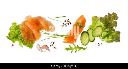 Smoked salted salmon fish filet slices with vegetables, spices and herbs flying falling isolated on white background. Healthy food collection. Stock Photo