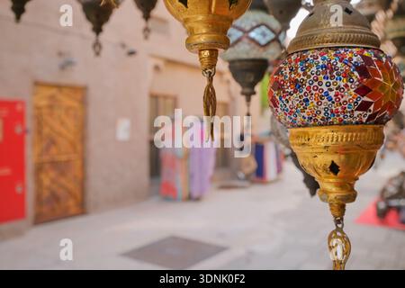 Traditional mosaic lanterns hanging in Middle Eastern souk street. Colorful handmade lamps creating authentic oriental atmosphere Stock Photo