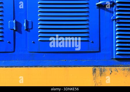 Industrial Blue Panel with Vents and Yellow Base Stock Photo