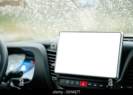 Angled shot of a car's interior featuring a large blank white display for interface design and navigation maps. Stock Photo