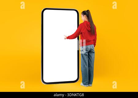 Design Concept of a Person Interacting With a Large Blank Screen Against a Bright Background Stock Photo