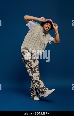 Cheerful young man showcases his unique fashion sense with playful poses and stylish attire. Stock Photo