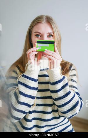 Smiling woman holding credit card for online shopping concept Stock Photo