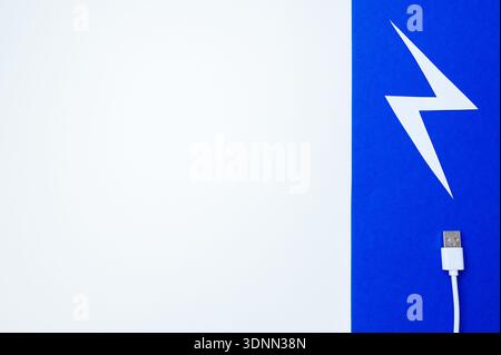Clean Composition Showcasing USB Cable Near Stylized Lightning Shape On Vibrant Background Stock Photo