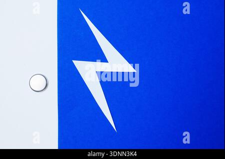 Tiny Blue Power Button Cell With Shiny Metal Edges Symbolizing Electronic Energy Flow Stock Photo