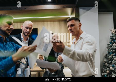 Business team reviews documents in a modern office during the holiday season Stock Photo