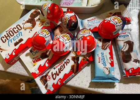 Kinder chocolate products and surprise eggs arranged on a table as a casual food assortment. Sarajevo, Bosnia and Herzegovina - 15 December 2025. Stock Photo