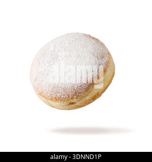 Single fresh baked donut sprinkled with sugar powder flying isolated on white background. Sweet doughnut closeup. Berliner donut. Pastry card. Stock Photo