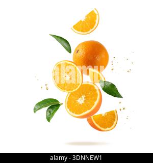 Fresh orange fruit whole and slices with drops and leaves falling flying isolated on white background Stock Photo