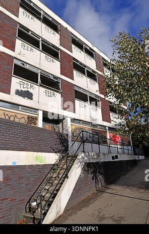 Vandalised and boarded up Victoria House office building on Wellington Street, Stockport, with repeated “FEER” graffiti on upper floors Stock Photo