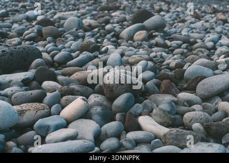 Close up of smooth volcanic river and sea pebbles. Stock Photo