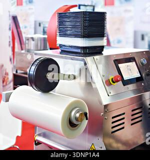 Industrial machine for packing plastic boxes in food production Stock Photo