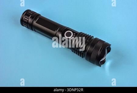 Black electric pocket flashlight, isolated on white .Black modern LED tactical flashlight isolated on white background Stock Photo
