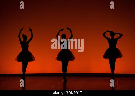 Ballet Dancers Silhouettes at Sunset Stage Stock Photo