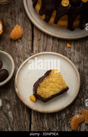 Bundt cake with citrus fruit, chocolate icing and chocolate eggs Stock Photo