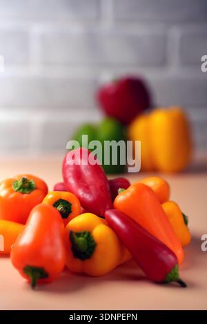 vibrant red, yellow, and orange bell peppers artfully arranged in a cozy kitchen setting, evoking a warm, inviting atmosphere with soft background and Stock Photo