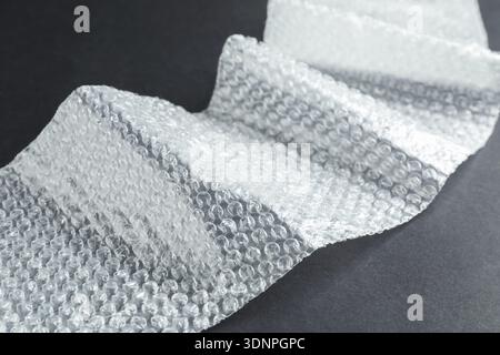Transparent bubble wrap on black background, closeup Stock Photo
