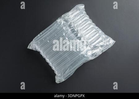 Transparent air buffer packaging on black background, top view Stock Photo