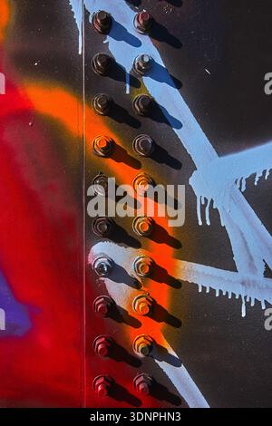 Graffiti Texture and Rusted Metal Bolts at Abandoned Water Park Structure Stock Photo