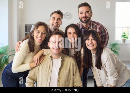 Happy group of young friends smiling together at home, casual team portrait Stock Photo