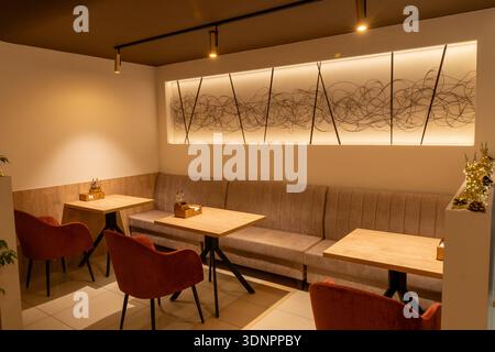 Interior restaurant with warm lighting and empty tables Stock Photo - Alamy
