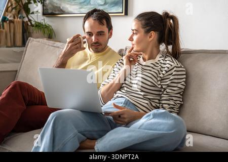 Married couple discussing family budget and planning expenses, trust and compromise in relationships Stock Photo