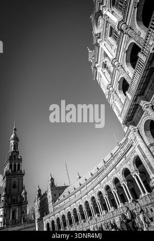 Sweeping curved façade of Plaza de España in Seville, Spain, highlighting its grand arches, ornate details, and impressive tower. Stock Photo