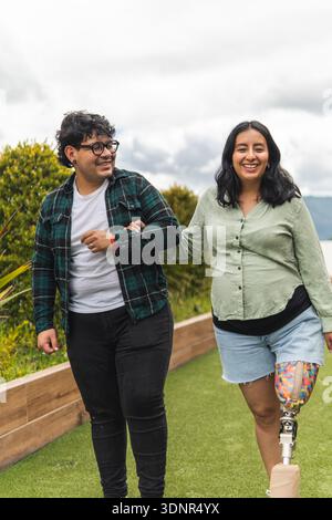 Happy couple  with pregnant woman walking outdoors showing inclusivity and diversity Stock Photo
