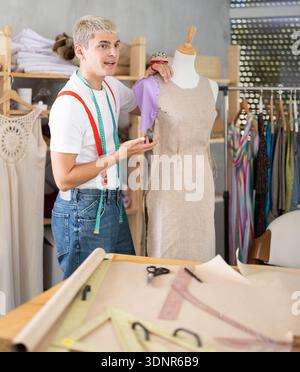 Young male tailor working with mannequin Stock Photo