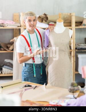 Young male tailor working with mannequin Stock Photo