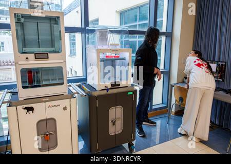 Miami Beach Florida,Main Public Library,3D printers Ultimaker digital fabrication area,man adult standing,talking with woman adult leaning toward comp Stock Photo