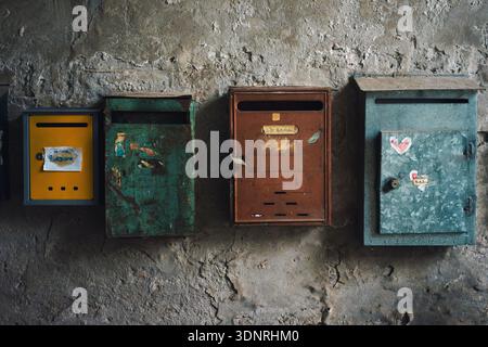 Old rusty mailbox on old dilapidated wall, close up detail. Stock Photo