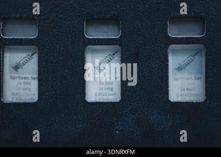 Close-up view of medical syringe sets in blue packaging Stock Photo