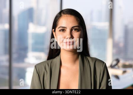 Positive beautiful Latin business leader woman posing for head shot Stock Photo