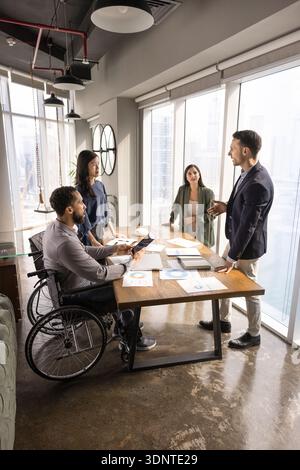 Diverse staff of company with inclusive policy meeting in boardroom Stock Photo
