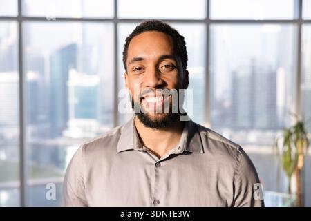Happy handsome African American business leader man posing in office Stock Photo