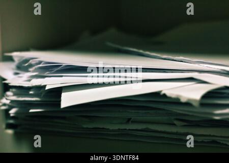 Pile of papers on a top of an officer table. Stock Photo