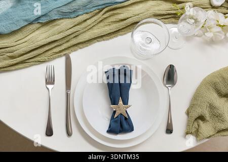 Elegant table setting with plates, folded napkin and cutlery Stock Photo