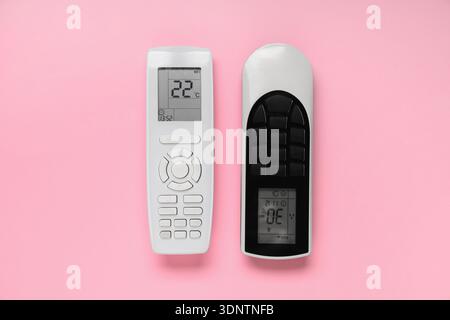 Air conditioner remote controls on pink background Stock Photo