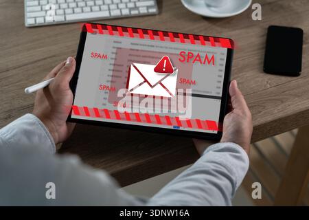 Cyber attack and spam mail concept System hacked warning malware warning on tablet screen, representing hacked system alerts, spyware detection, netwo Stock Photo