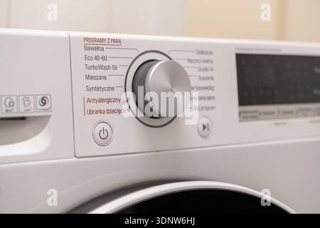 Modern washing machine control panel, featuring rotary knob, power button, and diverse settings for streamlined home laundry efficiency Stock Photo