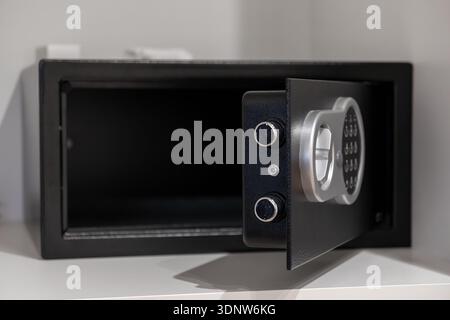 Close-up of an empty open electronic safe featuring a modern digital keypad, ensuring secure storage for valuables in hotel rooms or residential setti Stock Photo