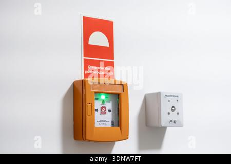 Krakow, Poland - November 30, 2025: Orange fire control button with green light, 'Opening fire dampers' sign, beside 'Ventilation' panel, essential fo Stock Photo