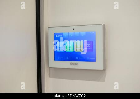 Krakow, Poland - November 30, 2025: Greon video intercom system, sleek wall-mounted control with bright blue digital interface, enabling intelligent r Stock Photo
