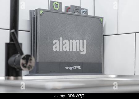 Krakow, Poland - November 30, 2025: KonigHOFFER gray plastic cutting boards, with symbols for cross-contamination prevention, neatly stored in a kitch Stock Photo