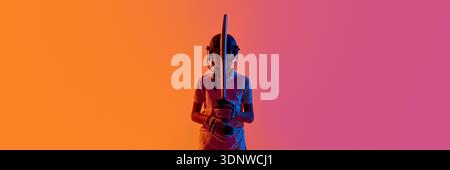 Cricket batsman standing front view with bat upright in neon studio. Banner Stock Photo