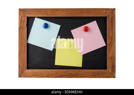Blank colorful notepapers on magnetic blackboard isolated on white background. Information or memo concept. Black memo board with copy space Stock Photo